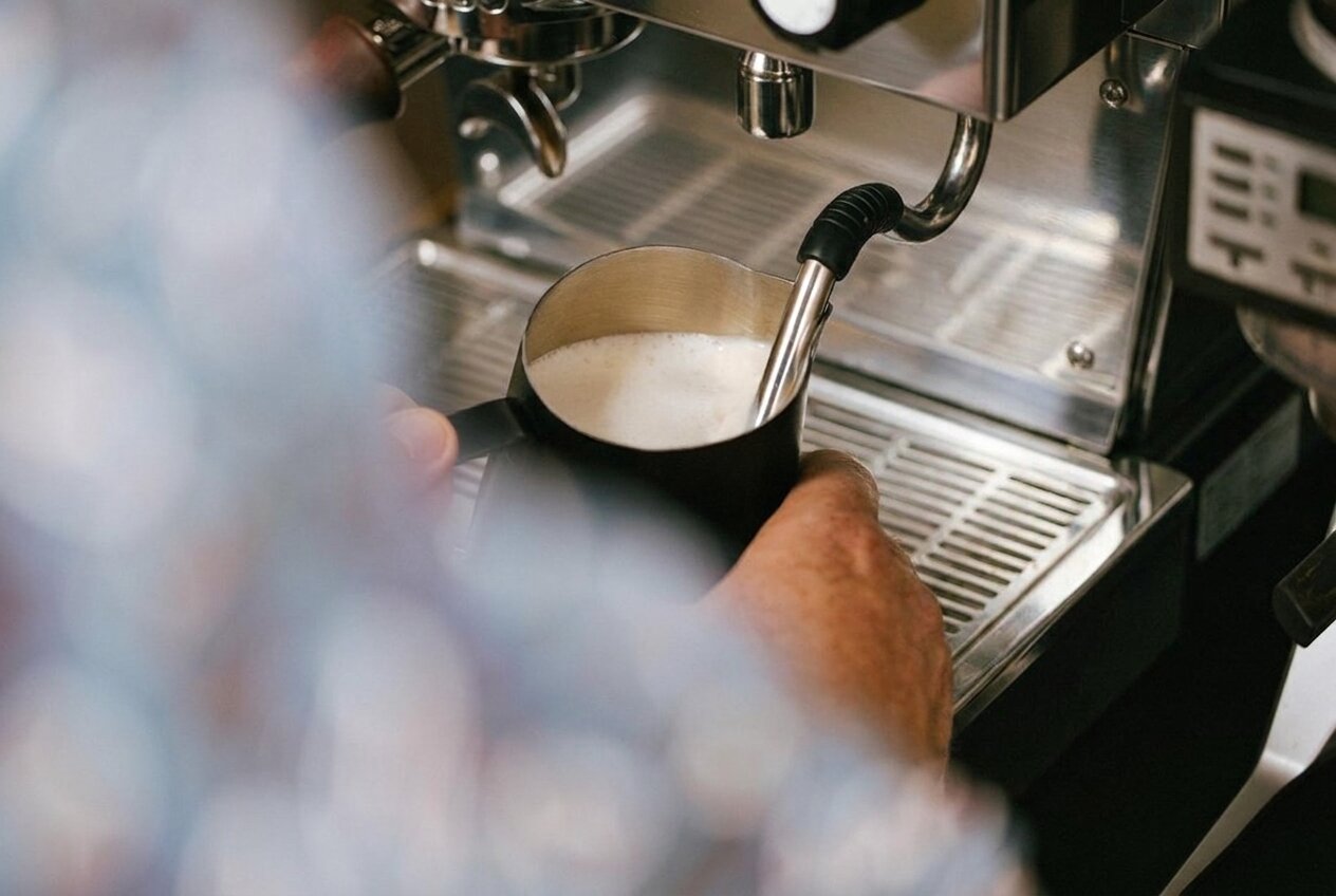 JoyBlast barista steaming milk on the espresso machine